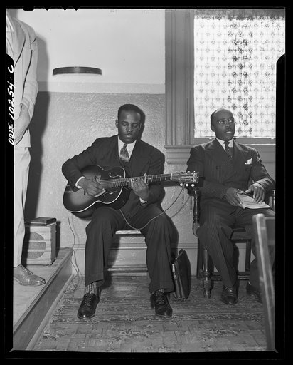 Washington, D.C. A young deacon doubling on the guitar at the Church of God in Christ