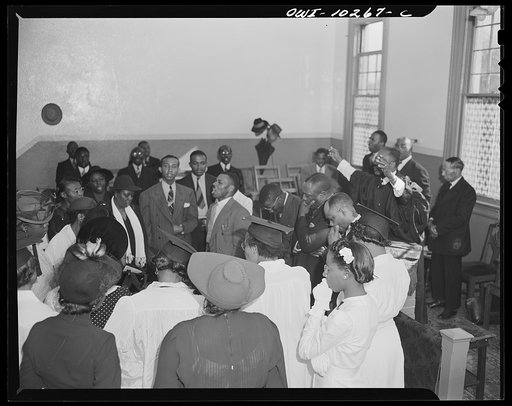 Washington, D.C. Elder Kelsey, pastor of the Church of God in Christ, blessing his Sunday morning congregation