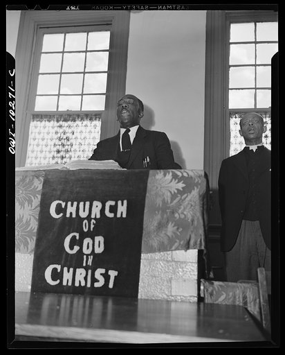 Washington, D.C. Elder Kelsey, pastor of the Church of God in Christ, opening a service with a song