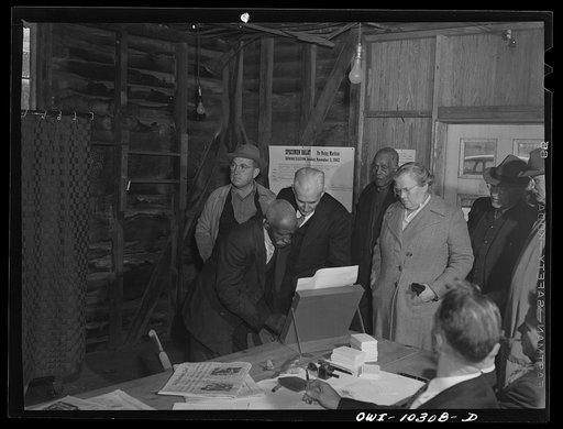 Olney, Maryland. Showing a Negro how to vote at the polls on election day