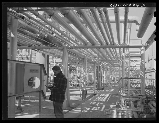 Gasoline plant employee checking a meter