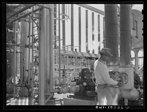 Gasoline plant employee operating a valve on a fractionating tower at the Phillips gasoline plant