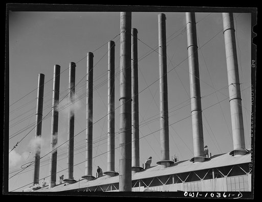 Untitled photo, possibly related to: Smokestacks at a boiler house at the Phillips gasoline plant