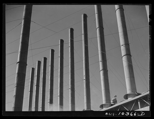 Untitled photo, possibly related to: Smokestacks at a boiler house at the Phillips gasoline plant