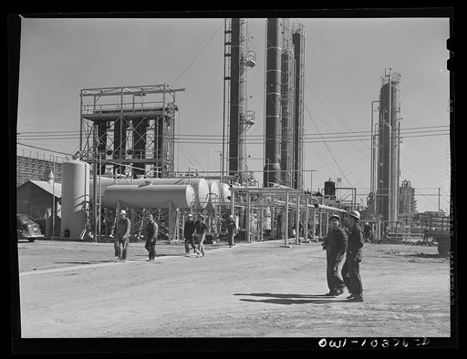 Untitled photo, possibly related to: Workers leaving a gasoline plant at a change of shift