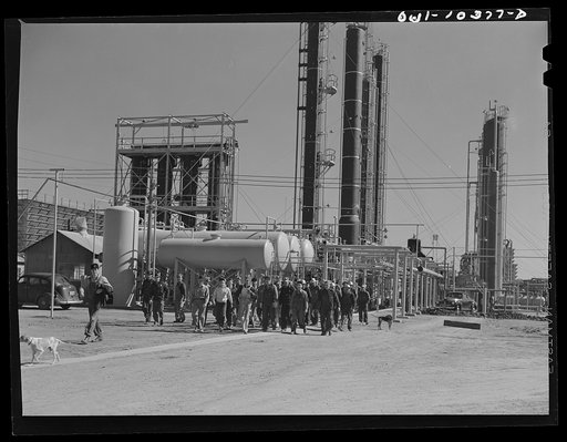 Workers leaving a gasoline plant at a change of shift