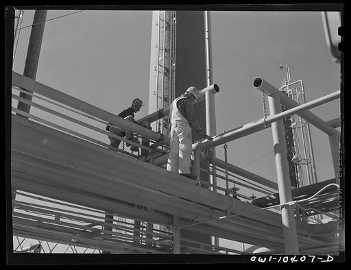 Workers making repairs in a pipeline system