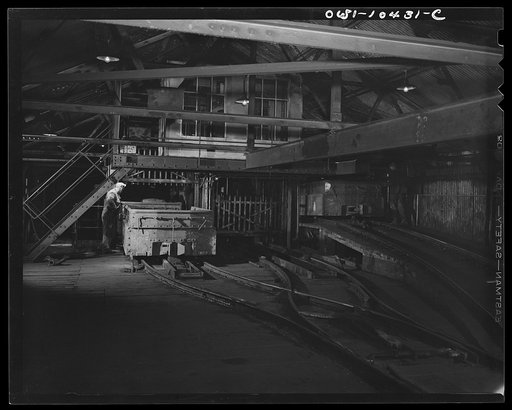 Untitled photo, possibly related to: Pittsburgh, Pennsylvania (vicinity). Montour no. 4 mine of the Pittsburgh Coal Company. Interior of a tipple where loaded coal cars are raised from the floor of the mine in an elevator called the "cage", then by means of a rotary dump the coal is emptied into rai