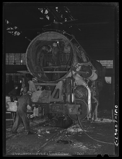 Chicago, Illinois. In the roundhouse at an Illinois Central Railroad yard. This former switching engine is being rebuilt for use on the road