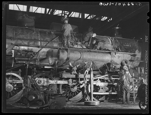 Chicago, Illinois. In the roundhouse at an Illinois Central Railroad yard. This former switching engine is being rebuilt for use on the road