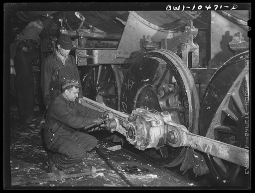 Chicago, Illinois. Working on the driving yard connection of a locomotive at the roundhouse of an Illinois Central Railroad yard