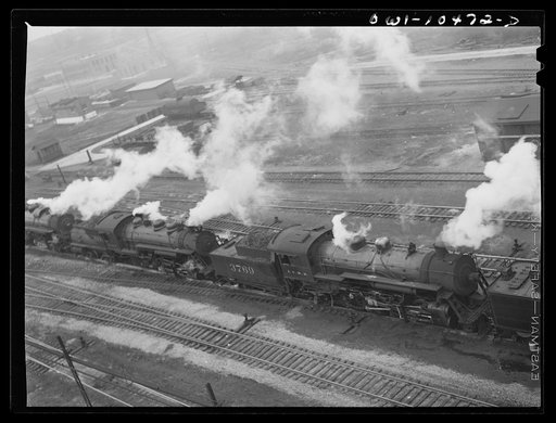 Untitled photo, possibly related to: Chicago, Illinois. An oil train from the Southwest leaves an Illinois Central Railroad yard for the Pennsylvania railroad to be sent on to the east