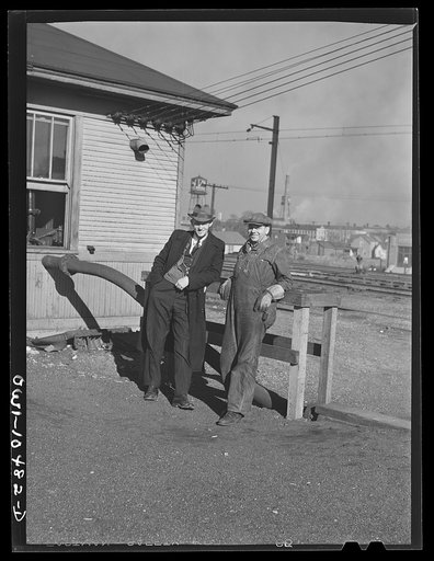 Untitled photo, possibly related to: Chicago, Illinois. Cars coming over the south hump at an Illinois Central Railroad yard. Cars are checked by an engine foreman in the building on the right and weighed as they pass by a weighmaster in the building on the right