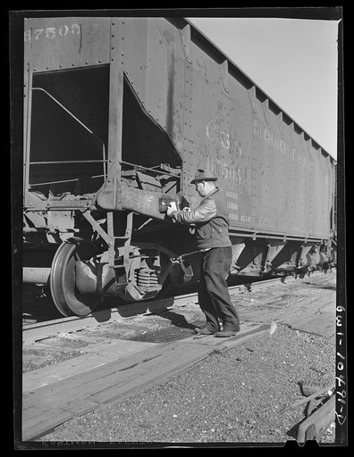 Untitled photo, possibly related to: Chicago, Illinois. Train clerk marking cars as they go over the hump at an Illinois Central Railroad yard