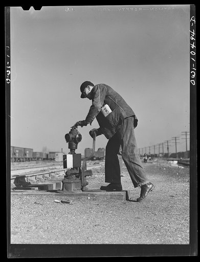 Chicago, Illinois. Throwing a switch after an Illinois Central Railroad train has gone by
