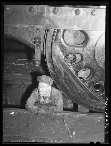 Chicago, Illinois. Workman in the roundhouse at an Illinois Central Railroad yard