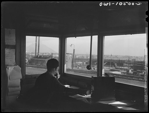 Untitled photo, possibly related to: Chicago, Illinois. Engine foreman checking cars as they go over the hump at an Illinois Central Railroad yard
