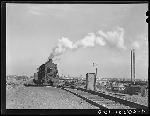 Chicago, Illinois. Switch engine which has just pushed its last car over the hump at an Illinois Central Railroad yard