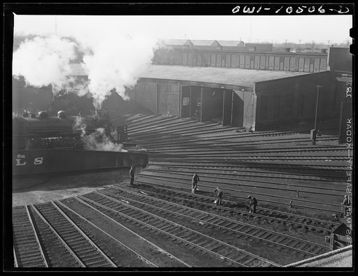 Untitled photo, possibly related to: Chicago, Illinois. A maintenance crew repairing tracks in the roundhouse at an Illinois Central Railroad yard