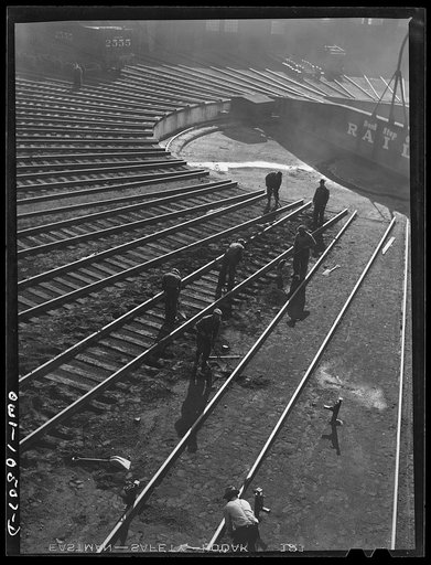 Chicago, Illinois. A maintenance crew repairing tracks in the roundhouse at an Illinois Central Railroad yard