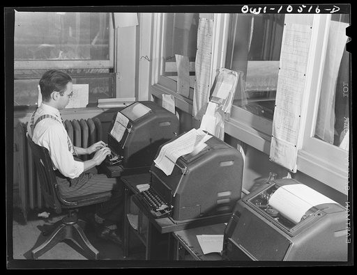 Chicago, Illinois. Switch lists are sent by teletype from the main yard office to yardmasters, tower men, and other offices at an Illinois Central Railroad yard