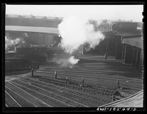 Untitled photo, possibly related to: Chicago, Illinois. A maintenance crew repairing tracks in the roundhouse at an Illinois Central Railroad yard