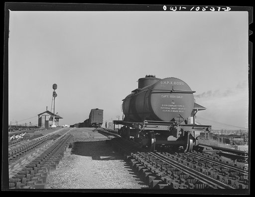 Chicago, Illinois. Tank car going over the retarder at the south hump at an Illinois Central Railroad yard