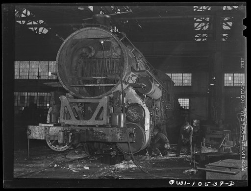 Chicago, Illinois. In the roundhouse at an Illinois Central Railroad yard. This switch engine is being converted into a road engine