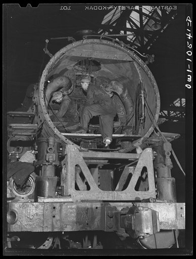 Chicago, Illinois. Locomotive repair in roundhouse at an Illinois Central Railroad yard