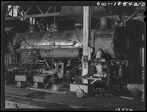 Chicago, Illinois. Locomotive repair in roundhouse at an Illinois Central Railroad yard