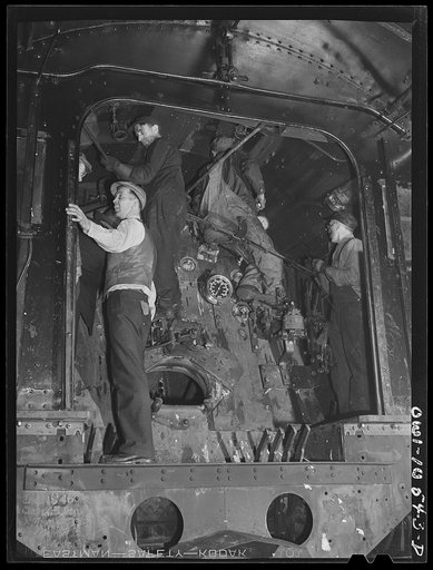 Chicago, Illinois. Locomotive repair in roundhouse at an Illinois Central Railroad yard