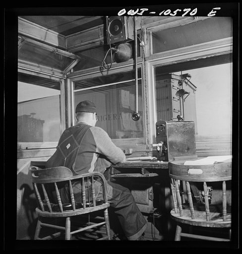 Chicago, Illinois. Car going over the hump past the engine foreman's office at an Illinois Central Railroad yard