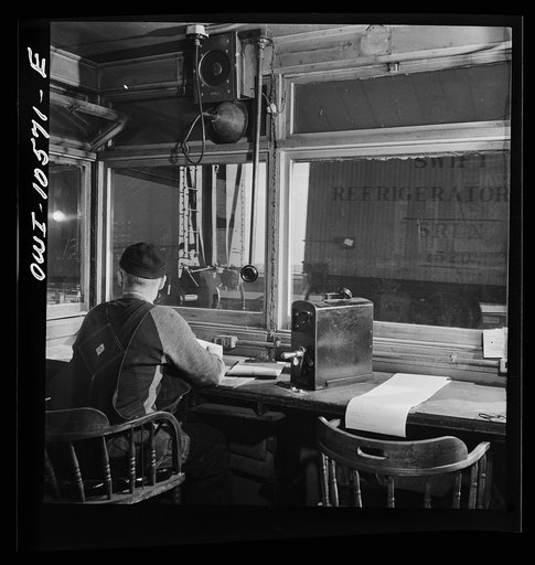 Untitled photo, possibly related to: Chicago, Illinois. Car going over the hump past the engine foreman's office at an Illinois Central Railroad yard