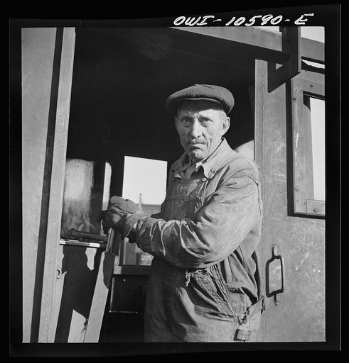 Chicago, Illinois. Turntable operator at the roundhouse at an Illinois Central Railroad yard