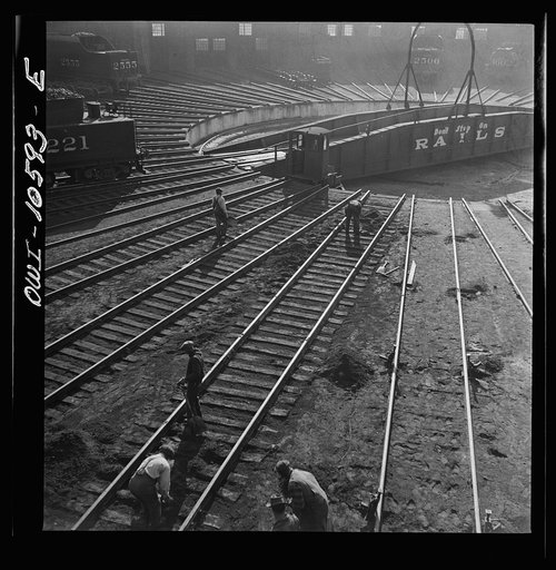 Chicago, Illinois. Track crews repairing tracks in the roundhouse at an Illinois railroad yard