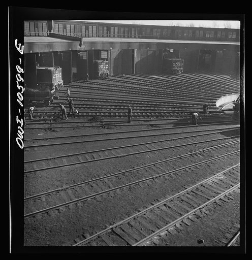 Untitled photo, possibly related to: Chicago. Illinois. Track crews repairing tracks in the roundhouse at an Illinois Central Railroad yard