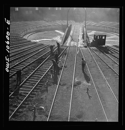 Untitled photo, possibly related to: Chicago. Illinois. Track crews repairing tracks in the roundhouse at an Illinois Central Railroad yard