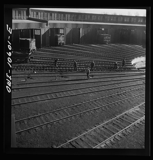 Chicago. Illinois. Track crews repairing tracks in the roundhouse at an Illinois Central Railroad yard