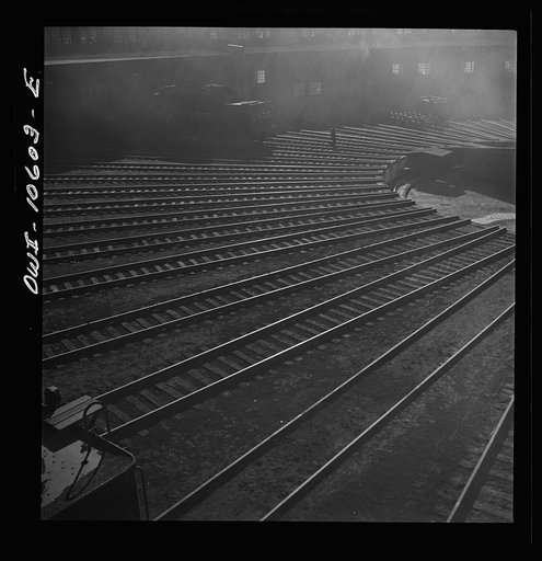 Untitled photo, possibly related to: Chicago. Illinois. Track crews repairing tracks in the roundhouse at an Illinois Central Railroad yard