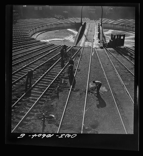 Chicago, Illinois. Track crews repairing tracks in the roundhouse at an Illinois Central Railroad yard