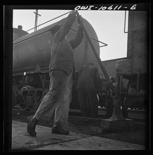 Untitled photo, possibly related to: Chicago, Illinois. Jacking up a car on the repair tracks at an Illinois Central Railroad yard