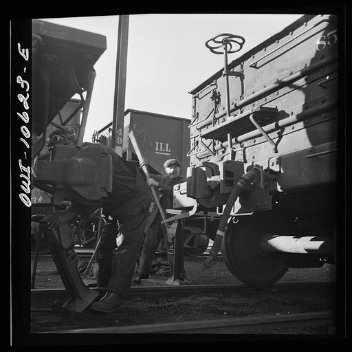 Untitled photo, possibly related to: Chicago, Illinois. Jacking up a car on the repair tracks at an Illinois Central Railroad yard