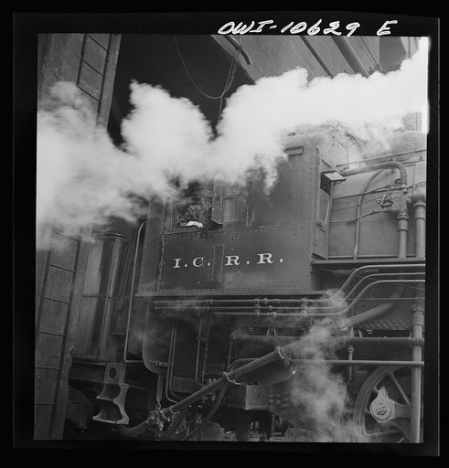 Chicago, Illinois. Locomotive picking up coal at an Illinois Central Railroad yard before going out on the road