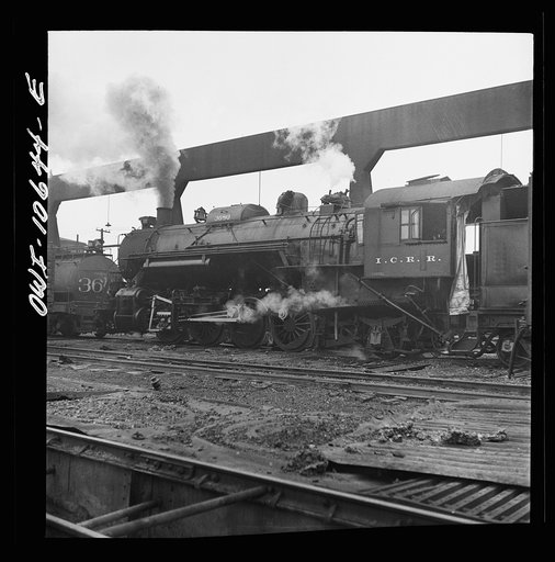 Chicago, Illinois. Locomotive taking on sand at an Illinois Central Railroad yard, before going out on the road