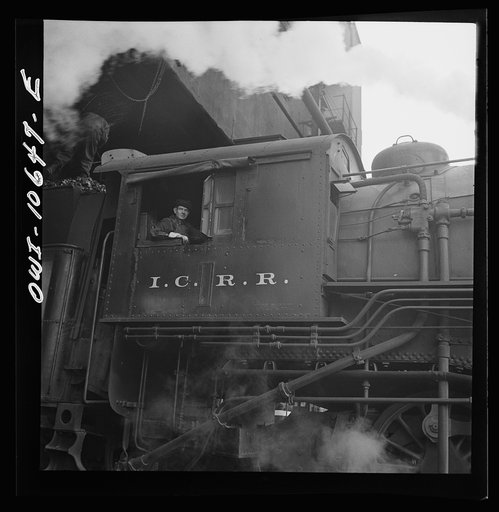 Untitled photo, possibly related to: Chicago, Illinois. Engine taking on coal at an Illinois Central Railroad yard