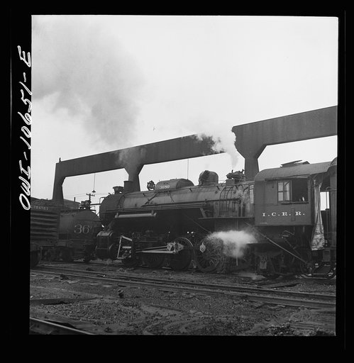 Untitled photo, possibly related to: Chicago, Illinois. Locomotive taking on sand at an Illinois Central Railroad yard, before going out on the road