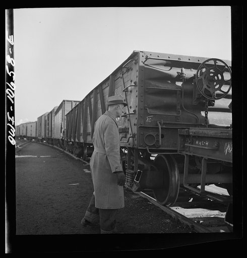 Untitled photo, possibly related to: Chicago, Illinois. Uncoupling cars as they go over the hump at an Illinois Central Railroad yard