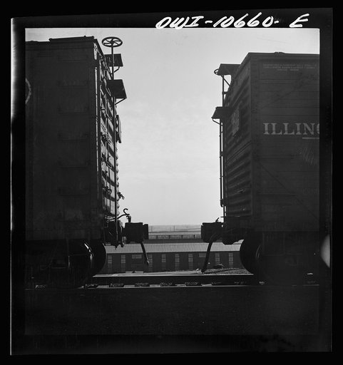 Untitled photo, possibly related to: Chicago, Illinois. Cars are uncoupled at the top of the hump and roll down by gravity at an Illinois Central Railroad yard to the classification yards