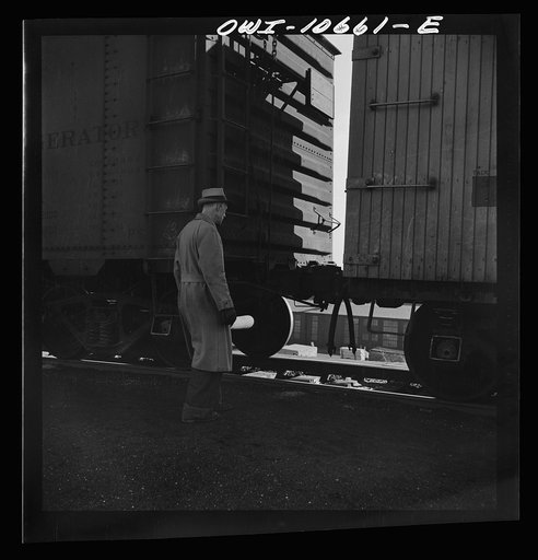 Untitled photo, possibly related to: Chicago, Illinois. Cars are uncoupled at the top of the hump and roll down by gravity at an Illinois Central Railroad yard to the classification yards