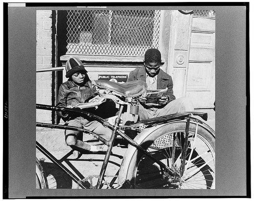 Washington, D.C. Two Negro boys reading the funnies on a doorstep